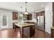 Bright kitchen with stainless steel appliances, granite countertops, and a kitchen island at 5925 Pine Bluff Dr, Cumming, GA 30040