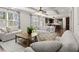 Comfortable living room with large windows and an open view of the kitchen at 5925 Pine Bluff Dr, Cumming, GA 30040