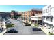 Commercial parking area surrounded by upscale retail buildings and outdoor dining spaces at 5925 Pine Bluff Dr, Cumming, GA 30040