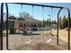 Community playground featuring swings, slides, and picnic area with tables and covered seating at 5925 Pine Bluff Dr, Cumming, GA 30040