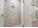 Modern shower design with mosaic tile surround and seamless glass door at 5925 Pine Bluff Dr, Cumming, GA 30040