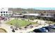 Aerial view of town square featuring a well-maintained green space, outdoor seating, and nearby restaurants at 5925 Pine Bluff Dr, Cumming, GA 30040