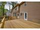 A spacious wood deck with stairs offers views of the house's exterior and the surrounding landscape at 2611 Rock Point Ln, Snellville, GA 30039