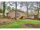 Exterior backyard featuring a deck, walkout basement and large lawn with mature trees at 2611 Rock Point Ln, Snellville, GA 30039