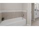 Bathtub featuring tile backsplash and modern fixtures at 2611 Rock Point Ln, Snellville, GA 30039