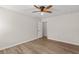 A bedroom with wood-look flooring, a ceiling fan, and natural light at 2611 Rock Point Ln, Snellville, GA 30039