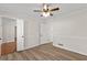 Bright bedroom features neutral walls, modern ceiling fan, and new hardwood floors at 2611 Rock Point Ln, Snellville, GA 30039