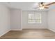 A bedroom with wood-look flooring, a ceiling fan, and natural light at 2611 Rock Point Ln, Snellville, GA 30039