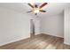 A bright bedroom features wood-look flooring and a ceiling fan at 2611 Rock Point Ln, Snellville, GA 30039