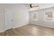 A bedroom with a ceiling fan, wood-look flooring, and two windows at 2611 Rock Point Ln, Snellville, GA 30039