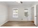 Bright bedroom features neutral walls, modern ceiling fan, two windows and new hardwood floors at 2611 Rock Point Ln, Snellville, GA 30039