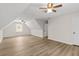 A large bonus room offers wood-look flooring, a ceiling fan, and natural light at 2611 Rock Point Ln, Snellville, GA 30039
