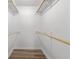 Walk-in closet featuring shelving and wood flooring at 2611 Rock Point Ln, Snellville, GA 30039
