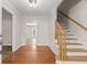 Bright foyer with hardwood floors, staircase, and views into other living spaces at 2611 Rock Point Ln, Snellville, GA 30039