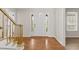 Inviting foyer featuring hardwood floors, a staircase, and a white front door with sidelights at 2611 Rock Point Ln, Snellville, GA 30039