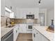 Modern kitchen with stainless steel appliances, granite countertops, tile backsplash and white cabinets at 2611 Rock Point Ln, Snellville, GA 30039