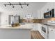 Modern kitchen with stainless steel appliances, granite countertops and white cabinets at 2611 Rock Point Ln, Snellville, GA 30039