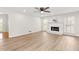 Bright living room features modern flooring, a fireplace, and large windows at 2611 Rock Point Ln, Snellville, GA 30039