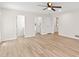 Light filled living room with laminate flooring, white walls, and multiple doorways at 2611 Rock Point Ln, Snellville, GA 30039