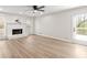 Bright living room features modern flooring, a fireplace, and a ceiling fan at 2611 Rock Point Ln, Snellville, GA 30039