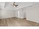 Spacious main bedroom featuring tray ceilings, ceiling fan, and light wood flooring at 2611 Rock Point Ln, Snellville, GA 30039