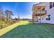 A large green backyard and bright, two-story home with a white exterior and a charming, covered wooden porch at 3330 Hillshire Dr, Cumming, GA 30028
