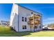 Expansive backyard featuring a covered wooden deck, lush green grass, and a two-story white home exterior at 3330 Hillshire Dr, Cumming, GA 30028