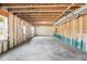 Unfinished basement showing wood beams, insulation, and a smooth concrete floor ready to be transformed at 3330 Hillshire Dr, Cumming, GA 30028