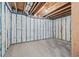 Unfinished basement with insulated walls, exposed ceiling beams, and poured concrete floors at 3330 Hillshire Dr, Cumming, GA 30028