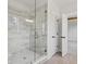 Modern bathroom features a glass-enclosed shower with tile surround and brushed gold hardware at 3330 Hillshire Dr, Cumming, GA 30028
