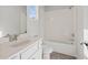 This bathroom has a white vanity, toilet, and shower-tub combo with tiled walls and floors at 3330 Hillshire Dr, Cumming, GA 30028