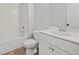 Bathroom featuring white vanity, toilet, and tub with tile surround at 3330 Hillshire Dr, Cumming, GA 30028