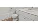 Bathroom featuring a white vanity, toilet, tub, and luxury vinyl plank flooring at 3330 Hillshire Dr, Cumming, GA 30028