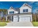 Charming two-story home with white siding, black shutters, and a two-car garage at 3330 Hillshire Dr, Cumming, GA 30028