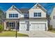 Charming two-story home with white siding, black shutters, and a two-car garage at 3330 Hillshire Dr, Cumming, GA 30028