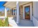 Inviting front porch featuring stone accents, white columns, and a wood front door at 3330 Hillshire Dr, Cumming, GA 30028