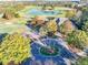 Aerial view of a well-manicured golf course with a pond, lush fairways, and a clubhouse, perfect for golf enthusiasts at 3330 Hillshire Dr, Cumming, GA 30028