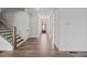 Entryway with hardwood staircase and view of the front door at 3330 Hillshire Dr, Cumming, GA 30028