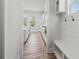 Bright hallway with luxury vinyl plank flooring and view into kitchen and pantry at 3330 Hillshire Dr, Cumming, GA 30028