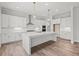 Bright kitchen featuring white cabinets, stainless steel appliances, and a large center island at 3330 Hillshire Dr, Cumming, GA 30028