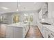 Spacious open kitchen with island, stainless steel appliances, and view to the outside deck at 3330 Hillshire Dr, Cumming, GA 30028