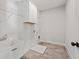 Large laundry room with utility sink, cabinets, and tile floors at 3330 Hillshire Dr, Cumming, GA 30028