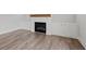 Living room featuring fireplace with wooden mantel and built-in cabinets and wood-look flooring at 3330 Hillshire Dr, Cumming, GA 30028