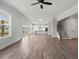 Open concept living room with wood-look floors, kitchen and staircase at 3330 Hillshire Dr, Cumming, GA 30028