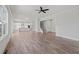 Spacious living room with wood-look flooring, kitchen, and staircase at 3330 Hillshire Dr, Cumming, GA 30028