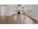 Open-concept living room with hardwood flooring, fireplace, and bright windows at 3330 Hillshire Dr, Cumming, GA 30028