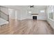 Open-concept living room with hardwood floors, a fireplace, and large windows for ample natural light at 3330 Hillshire Dr, Cumming, GA 30028