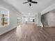 Spacious living room with luxury vinyl plank flooring and views of the kitchen and staircase at 3330 Hillshire Dr, Cumming, GA 30028