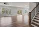 Spacious living room with hardwood floors, staircase, and natural light at 3330 Hillshire Dr, Cumming, GA 30028
