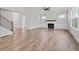Open-concept living room with hardwood flooring, fireplace, and bright windows at 3330 Hillshire Dr, Cumming, GA 30028
